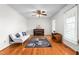 Bright living room with hardwood floors, white walls, and a gray and purple rug at 2169 Northcrest Dr, Elon, NC 27244