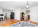 Open-concept living room with hardwood floors and modern lighting fixture at 2169 Northcrest Dr, Elon, NC 27244
