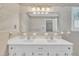 Bathroom featuring dual sinks, large mirror, and traditional accents at 229 Davis Mill Rd, Selma, NC 27576