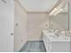 Bathroom with a large dual sink vanity, light fixtures, and mirror at 229 Davis Mill Rd, Selma, NC 27576