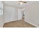 Bright bedroom features carpeted floor, windows, ceiling fan, and closet with bi-fold doors at 229 Davis Mill Rd, Selma, NC 27576