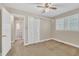 Bedroom with a ceiling fan, closet, and window overlooking a bathroom at 229 Davis Mill Rd, Selma, NC 27576