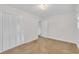 This bedroom features neutral carpet, white walls, and a large closet at 229 Davis Mill Rd, Selma, NC 27576
