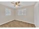 Bedroom with two windows, neutral carpet, white walls, and large closet at 229 Davis Mill Rd, Selma, NC 27576