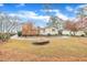 Charming home featuring mature trees, landscaping, and a well-maintained circular driveway at 229 Davis Mill Rd, Selma, NC 27576