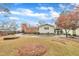 Well-maintained home with a spacious yard, established trees, and a stone firepit feature at 229 Davis Mill Rd, Selma, NC 27576