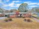 Aerial view showcasing the home's brick facade, established landscaping, and driveway at 229 Davis Mill Rd, Selma, NC 27576