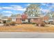 Classic brick home with mature trees and a well-kept lawn at 229 Davis Mill Rd, Selma, NC 27576