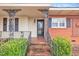 Charming front porch with brick steps and decorative iron railings at 229 Davis Mill Rd, Selma, NC 27576