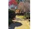 Picturesque garden path surrounded by vibrant flowering trees and bushes at 229 Davis Mill Rd, Selma, NC 27576