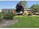 Charming brick home featuring a well-manicured lawn and mature landscaping at 229 Davis Mill Rd, Selma, NC 27576