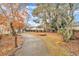 Landscaped front yard featuring a winding walkway and mature trees in a well-maintained residential setting at 229 Davis Mill Rd, Selma, NC 27576