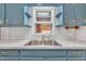 Kitchen sink with matching blue cabinetry and light countertops at 229 Davis Mill Rd, Selma, NC 27576