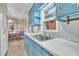 Kitchen sink and window, with blue cabinetry and light countertops at 229 Davis Mill Rd, Selma, NC 27576