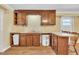 Kitchen area with wooden cabinets, offering ample storage, with space for dining and meal preparation at 229 Davis Mill Rd, Selma, NC 27576