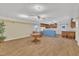 Large living room with wood floors, kitchen, and tables at 229 Davis Mill Rd, Selma, NC 27576