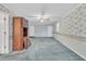 Living room with floral wallpaper, ceiling fan, carpet, and wooden hutch at 229 Davis Mill Rd, Selma, NC 27576