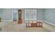Living room featuring an adjacent view of a room with blue wallpaper at 229 Davis Mill Rd, Selma, NC 27576
