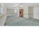 Living room with floral wallpaper, ceiling fan, carpet, and wooden hutch at 229 Davis Mill Rd, Selma, NC 27576