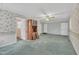 Living room with floral wallpaper, ceiling fan, carpet, and wooden hutch at 229 Davis Mill Rd, Selma, NC 27576