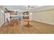 Large living room with wood floors, kitchen, and dining tables at 229 Davis Mill Rd, Selma, NC 27576
