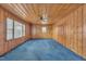 Wood-paneled room with a ceiling fan and light-filled windows at 229 Davis Mill Rd, Selma, NC 27576