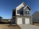 Charming two-story home with a two-car garage and stone accents at 350 Tormore, Homesite 126, Sanford, NC 27330