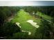 Aerial view of a lush golf course surrounded by dense trees, showing well-maintained greens and sand traps at 350 Tormore, Homesite 126, Sanford, NC 27330
