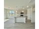 Bright kitchen featuring an island with granite countertops and stainless steel appliances at 350 Tormore, Homesite 126, Sanford, NC 27330