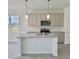 Bright kitchen featuring an island with granite countertops and stainless steel appliances at 350 Tormore, Homesite 126, Sanford, NC 27330
