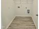 Functional laundry room with washer and dryer hookups, plus shelving at 350 Tormore, Homesite 126, Sanford, NC 27330