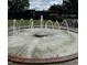 Circular water fountain in a park setting, complemented by a vintage steam train and verdant landscaping at 350 Tormore, Homesite 126, Sanford, NC 27330