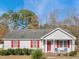 Gray house with red shutters, a covered porch, and landscaping at 512 Drexel Rd, Rocky Mount, NC 27803