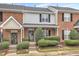 Charming brick townhome featuring manicured landscaping and inviting front entrance at 9009 Grassington Way, Raleigh, NC 27615