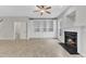 Bright living room with built-in cabinets and a corner fireplace feature at 9009 Grassington Way, Raleigh, NC 27615