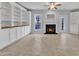 Bright living room with built-in bookshelves, fireplace and tile flooring at 9009 Grassington Way, Raleigh, NC 27615