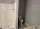 Bathroom with a white shower, toilet and sink and gray walls, plus wood look flooring at 1017 Gaston Ave, Durham, NC 27707