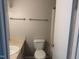 This bathroom features a shower, toilet, sink with cabinet, and tile floor at 1017 Gaston Ave, Durham, NC 27707