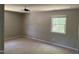A well-lit bedroom with neutral carpet and paint, plus a ceiling fan and single window at 1017 Gaston Ave, Durham, NC 27707