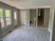 Open-concept living room with lots of natural light, new floors, and stairway access to the second level at 1017 Gaston Ave, Durham, NC 27707