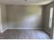 Spacious living room with a large window providing great natural light and modern flooring at 1017 Gaston Ave, Durham, NC 27707