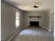 Open living room featuring a fireplace and ceiling fan, new flooring, and ample natural light at 1017 Gaston Ave, Durham, NC 27707
