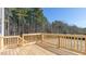 A wooden deck and railing face an open backyard and forest at 120 Tobacco Woods Dr, Youngsville, NC 27596