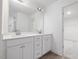 Bright bathroom featuring a double sink vanity with white cabinetry and a large mirror at 150 Whimbrel Ct, Lillington, NC 27546
