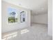 Well-lit bedroom featuring neutral carpet, recessed lighting, and natural light from large windows at 150 Whimbrel Ct, Lillington, NC 27546