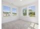 Bright bedroom featuring neutral carpet and large windows with neighborhood views at 150 Whimbrel Ct, Lillington, NC 27546