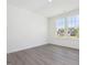 A bright bedroom featuring two large windows and modern vinyl flooring at 150 Whimbrel Ct, Lillington, NC 27546