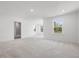 Spacious bedroom featuring neutral carpet, recessed lighting, and natural light from large windows at 150 Whimbrel Ct, Lillington, NC 27546