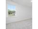 Bedroom featuring neutral carpet and a large window with views of the surrounding nature at 150 Whimbrel Ct, Lillington, NC 27546