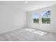 Bedroom featuring two windows and natural light at 150 Whimbrel Ct, Lillington, NC 27546